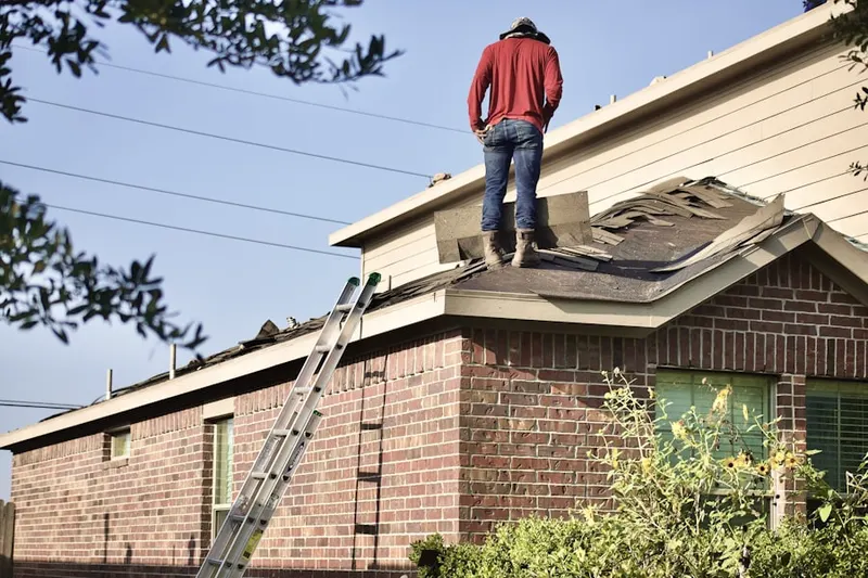 Professional roofer working on a residential roof in Westampton